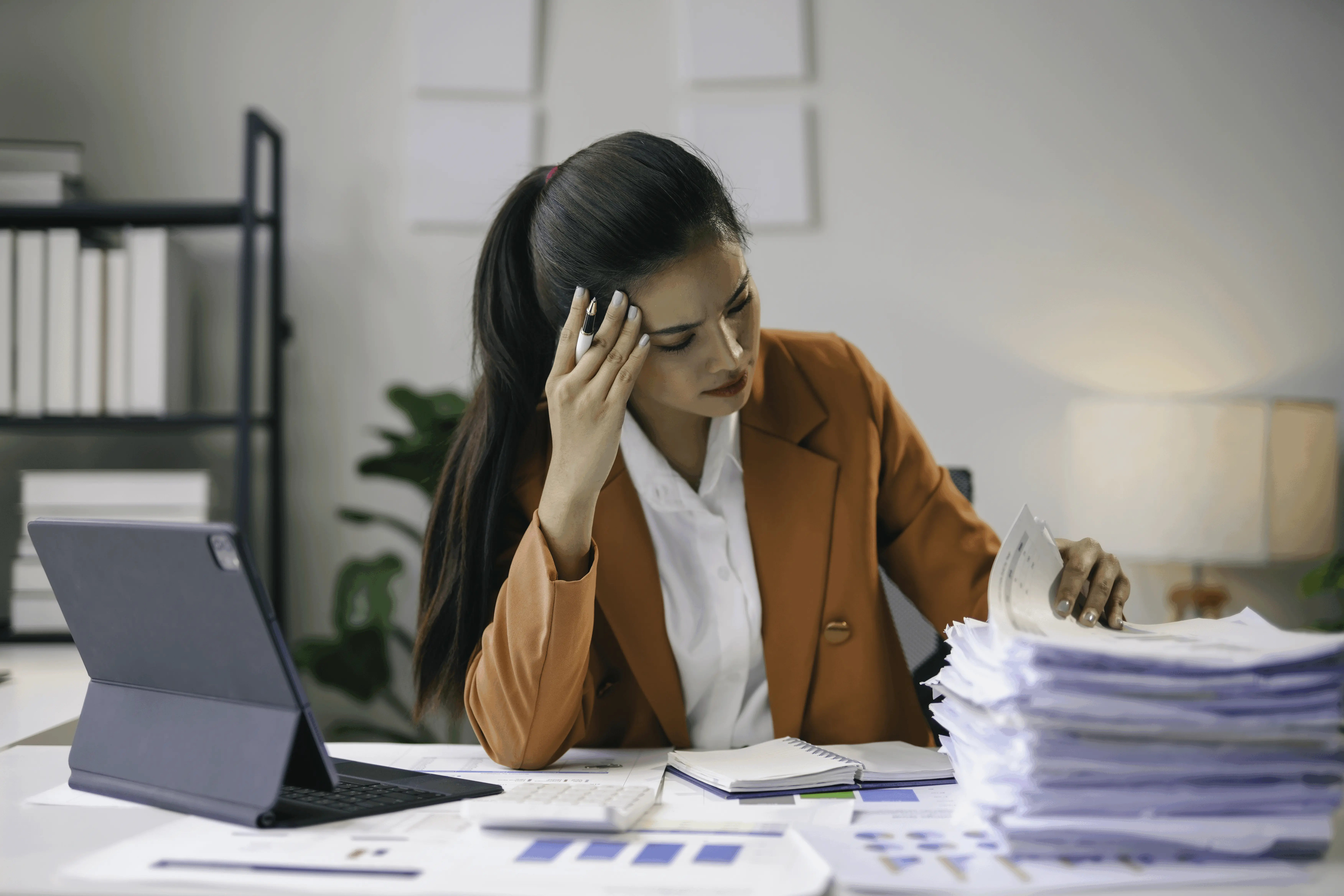 stressed-businesswoman-having-headache-while-worki-2025-02-20-17-34-55-utc-ezgif.com-speed